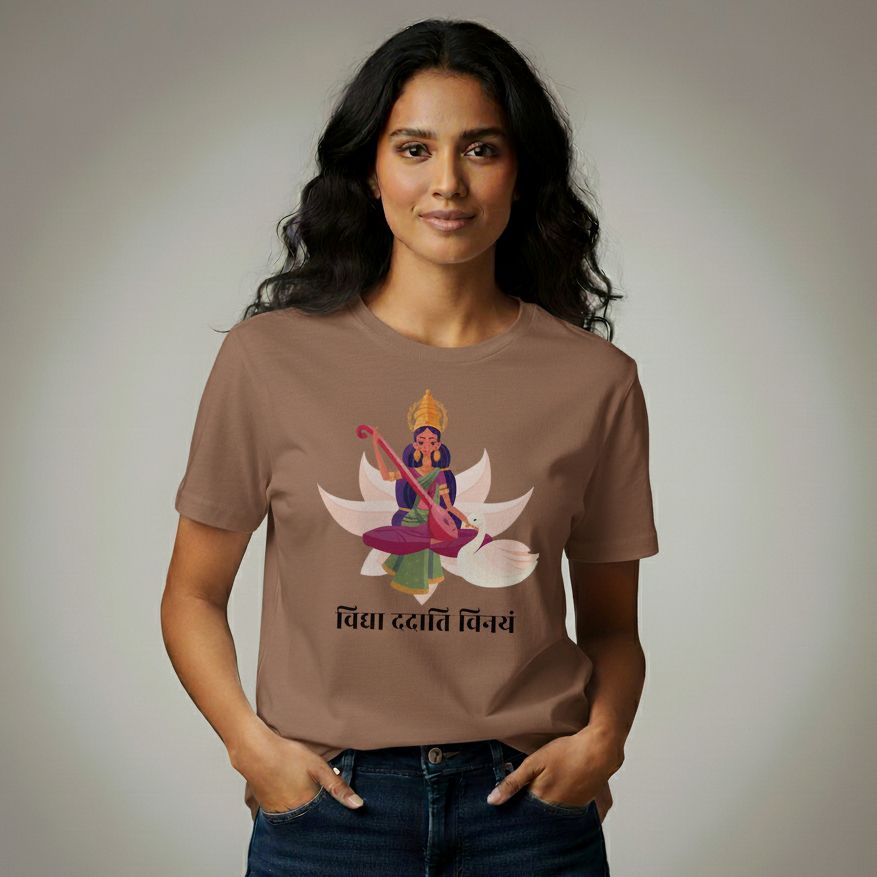 Woman wearing a brown t-shirt with a graphic design on a plain background
